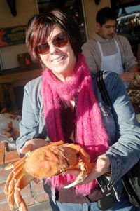 Barbara Adams holding a Dungeness crab at Fisherman’s Wharf.