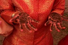 Tiny hands decorated with henna mendhi designs.