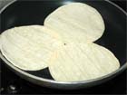 Warm tortillas for Mexican Tacos Bistek.