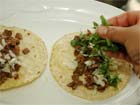 How to put toppings on Mexican Tacos Chorizo.