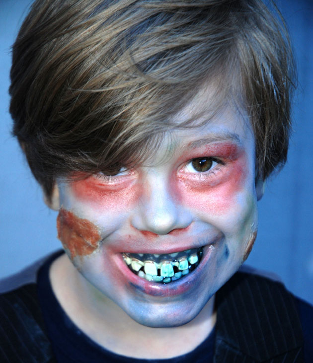 Zombie face paint makes the exploding cake even more fun.