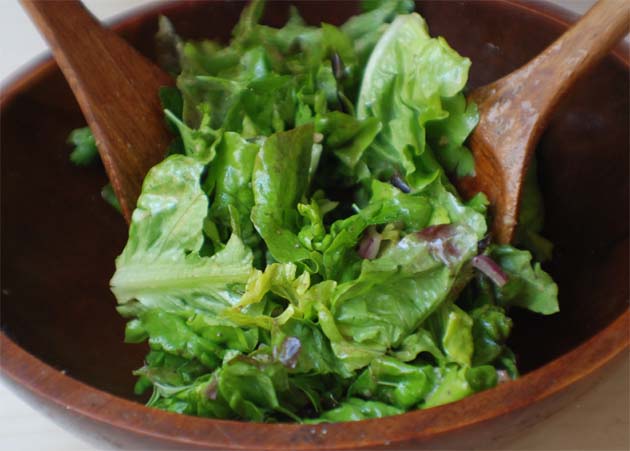 Toss the greens with vinaigrette.