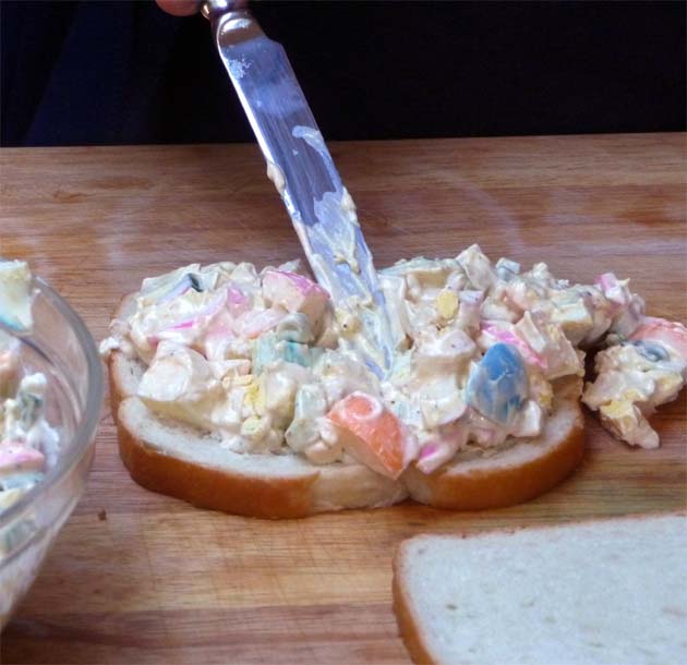 Slather egg salad on bread.
