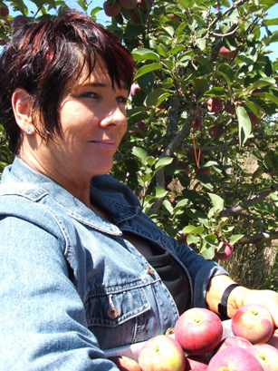 Barbara Adams picking apples with her family at the Gabriel organic farm in Sebastapol, California